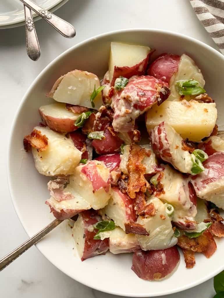 Dairy free potato salad in a white bowl.