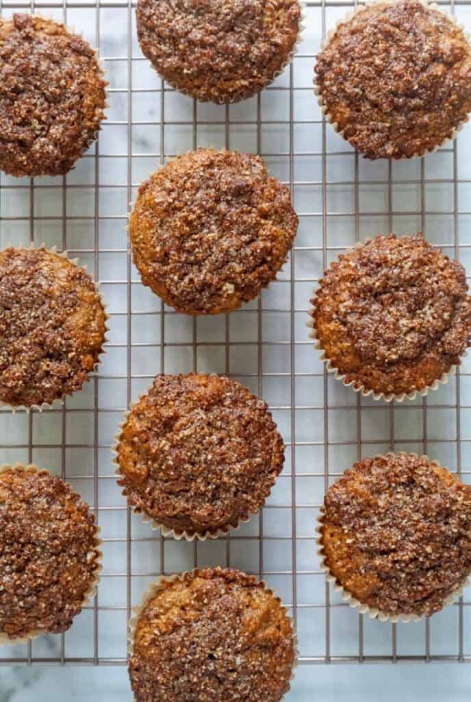 Apple muffins with crumb topping on cooling rack