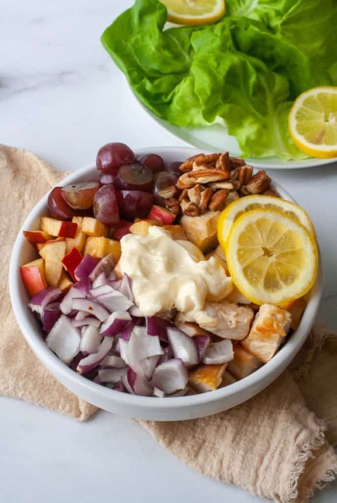 A white bowl filled with ingredients for salad.