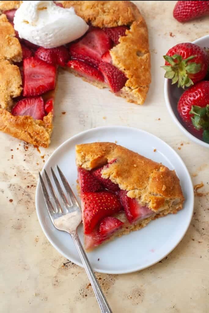 A gluten free strawberry galette on a white plate.
