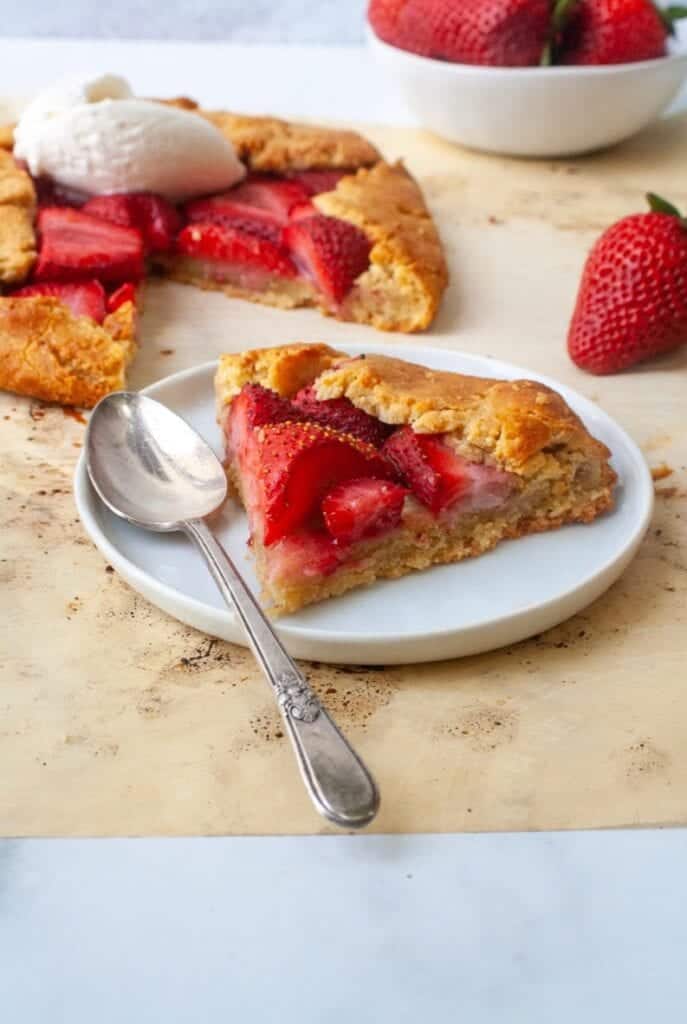 A piece of strawberry galette on a white plate.