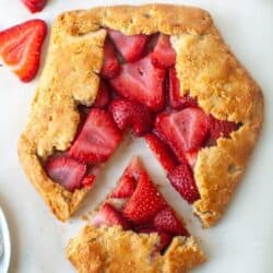 A gluten free strawberry galette on parchment paper.