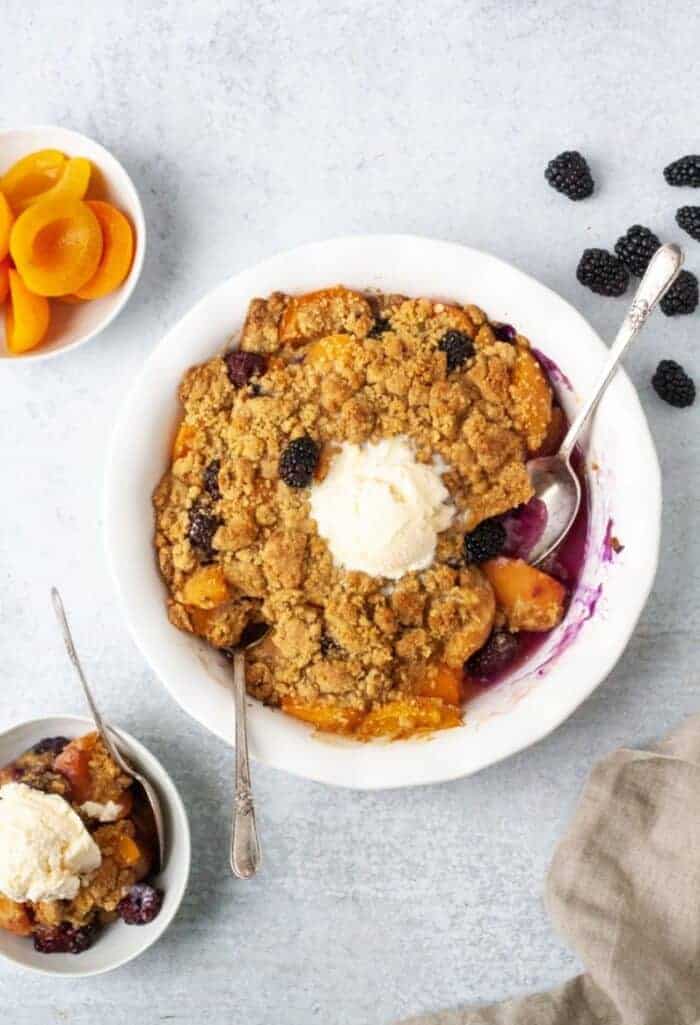 Paleo Vegan Apricot Blackberry Cobbler in a white pie dish.
