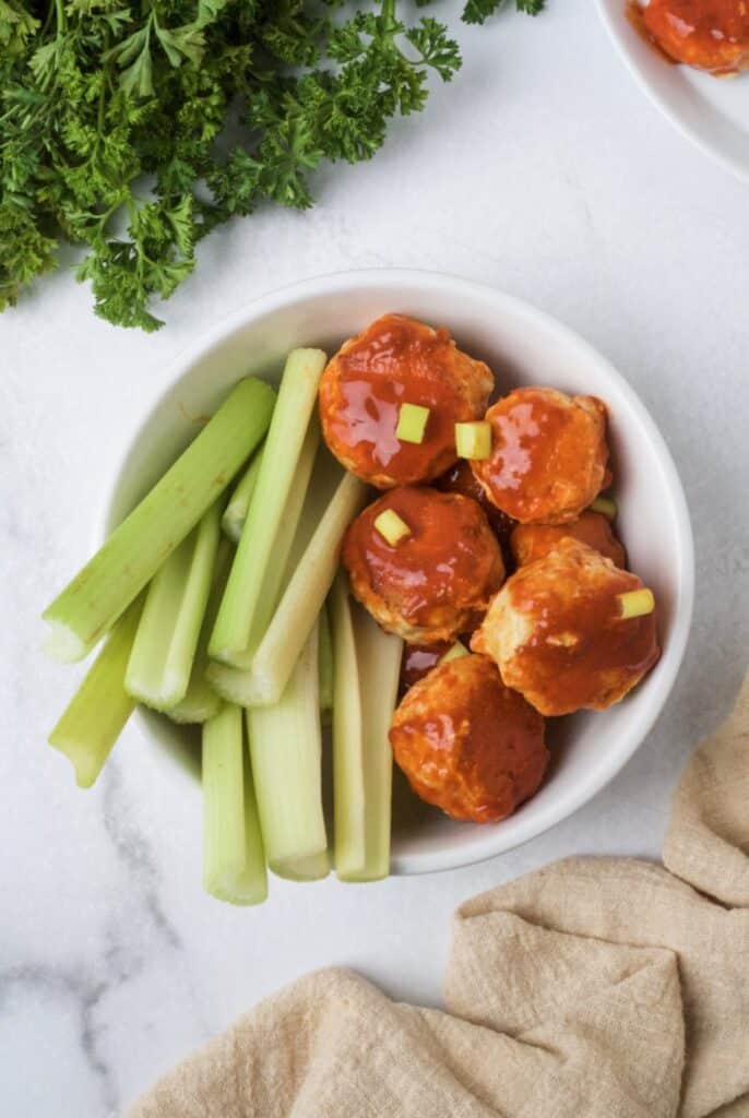 Whole30 chicken meatballs with buffalo sauce.