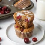Paleo Orange Cranberry Muffins on a white plate with a glass of milk.