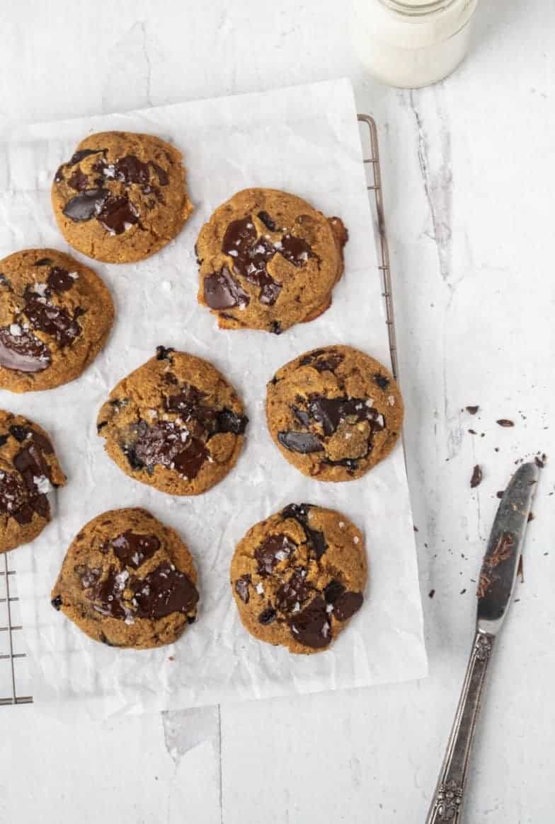 Paleo Orange Chocolate Chip Cookies on white parchment paper.