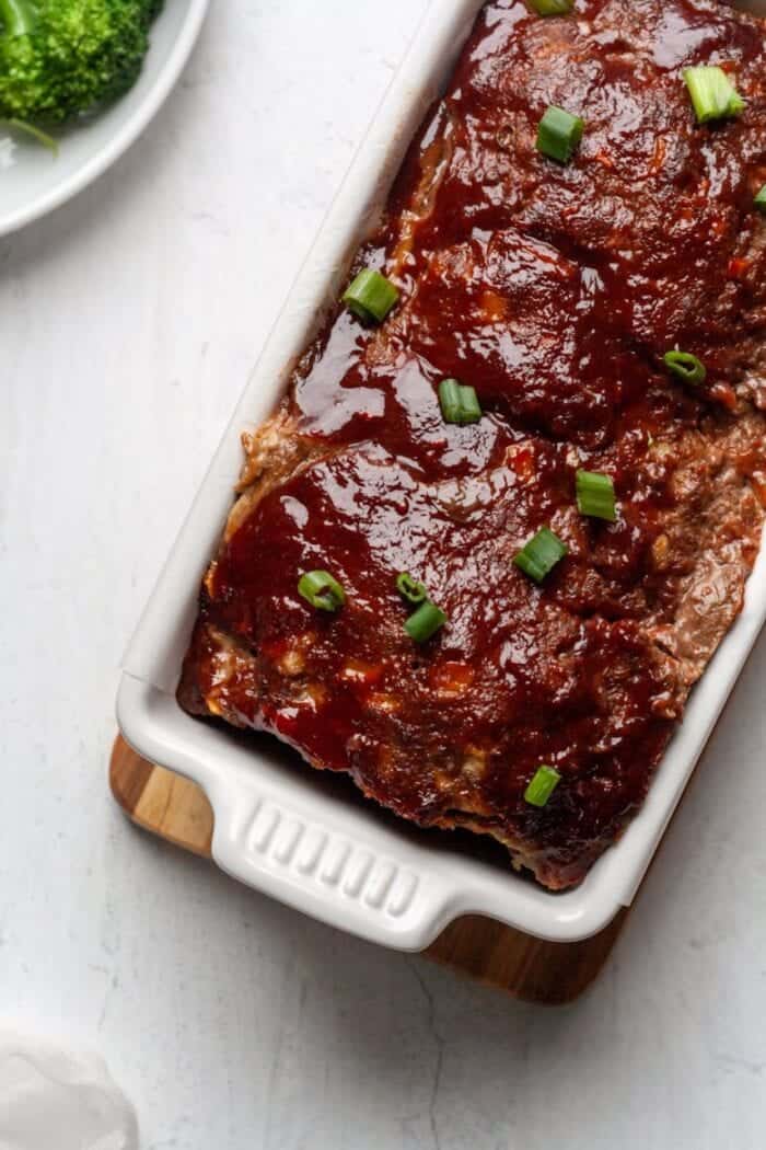 A Whole30 Paleo Asian Meatloaf in a white bread pan.
