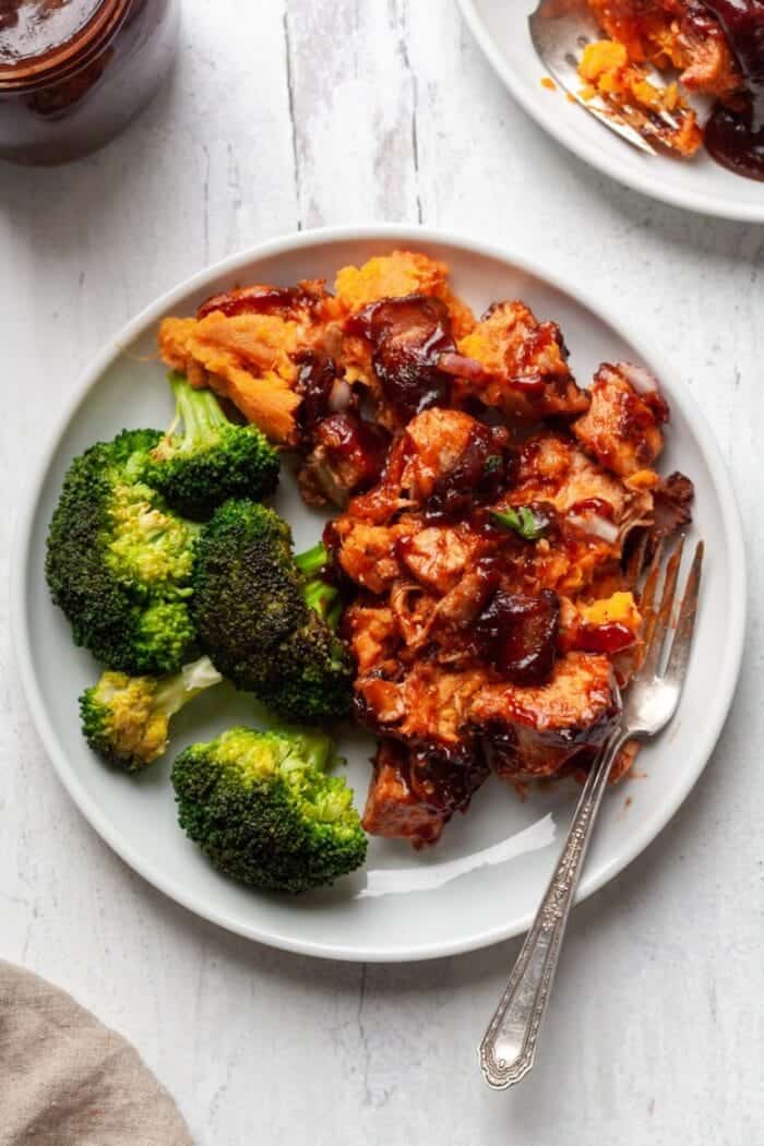 Whole30 BBQ Chicken Casserole on a white plate with broccoli.