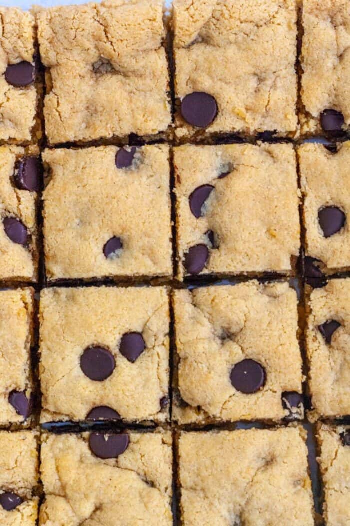 Almond flour blonde brownies cut into squares with chocolate chips.