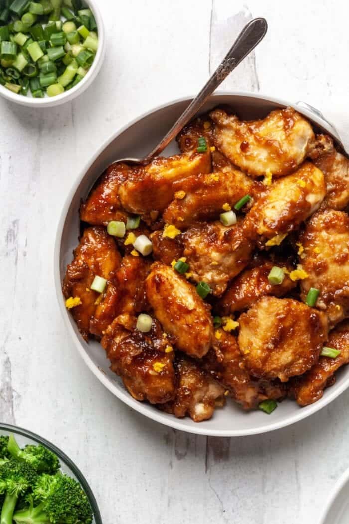 A white skillet filled with Orange Chicken.