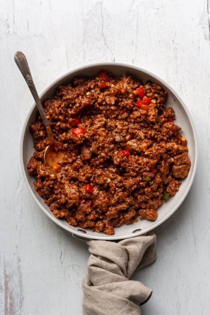 Ground beef with sauce in white skillet