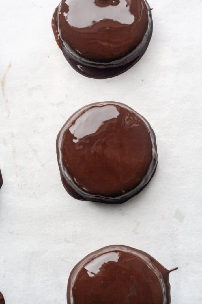 Gluten free thin mints on white parchment paper.