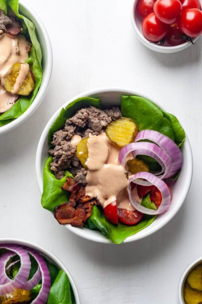 Whole30 burger bowls topped with Whole30 spicy mayo.