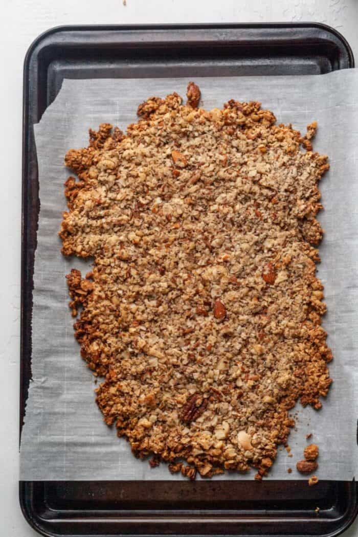 Homemade chunky granola on a baking sheet.