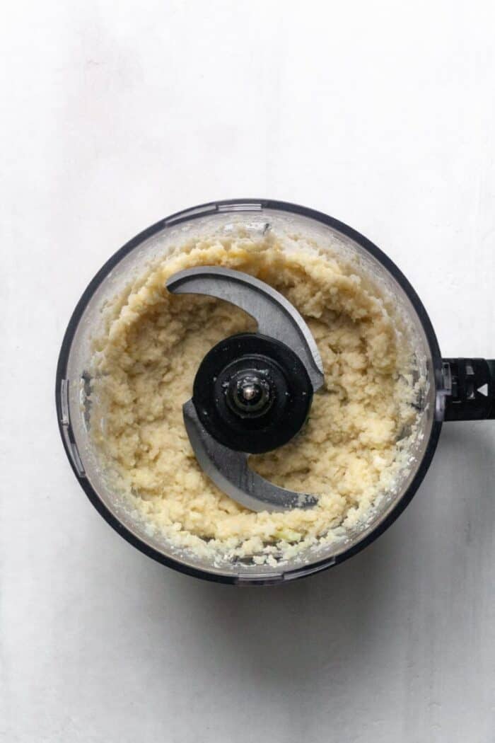 A food processor filled with Whole30 mashed cauliflower.