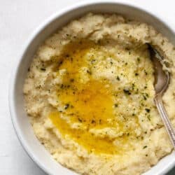 A white bowl filled with creamy Whole30 mashed cauliflower.