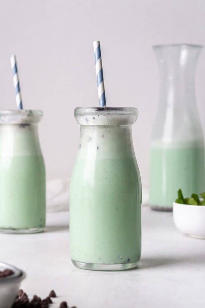 A glass jar filled with Dairy Free Mint chocolate smoothie.