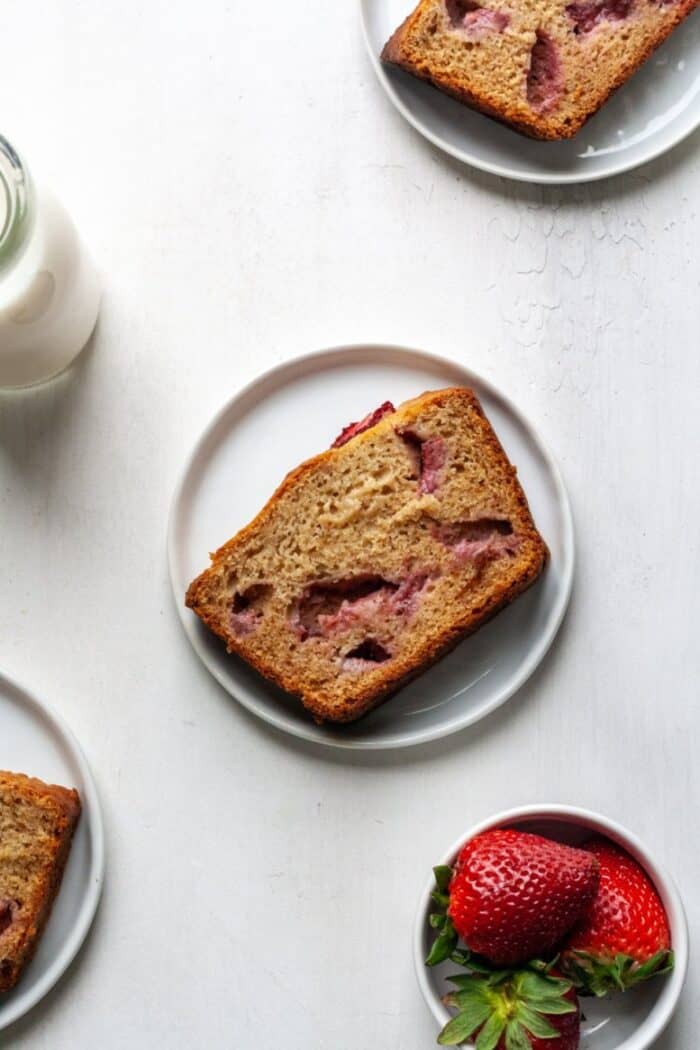 A piece of paleo strawberry banana bread on a white plate.
