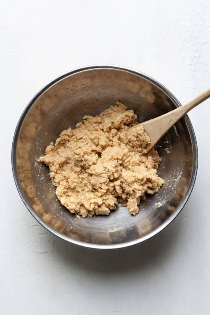Almond flour thumbprint cookie dough in a mixing bowl.