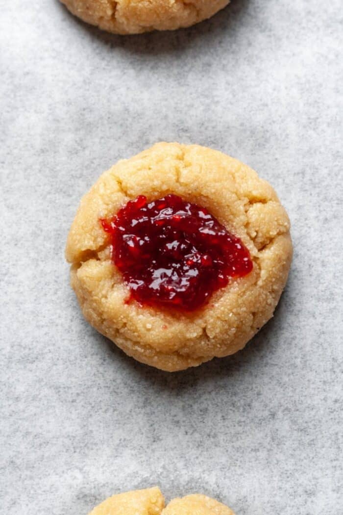 Almond flour thumbprint cookies filled with raspberry jam.