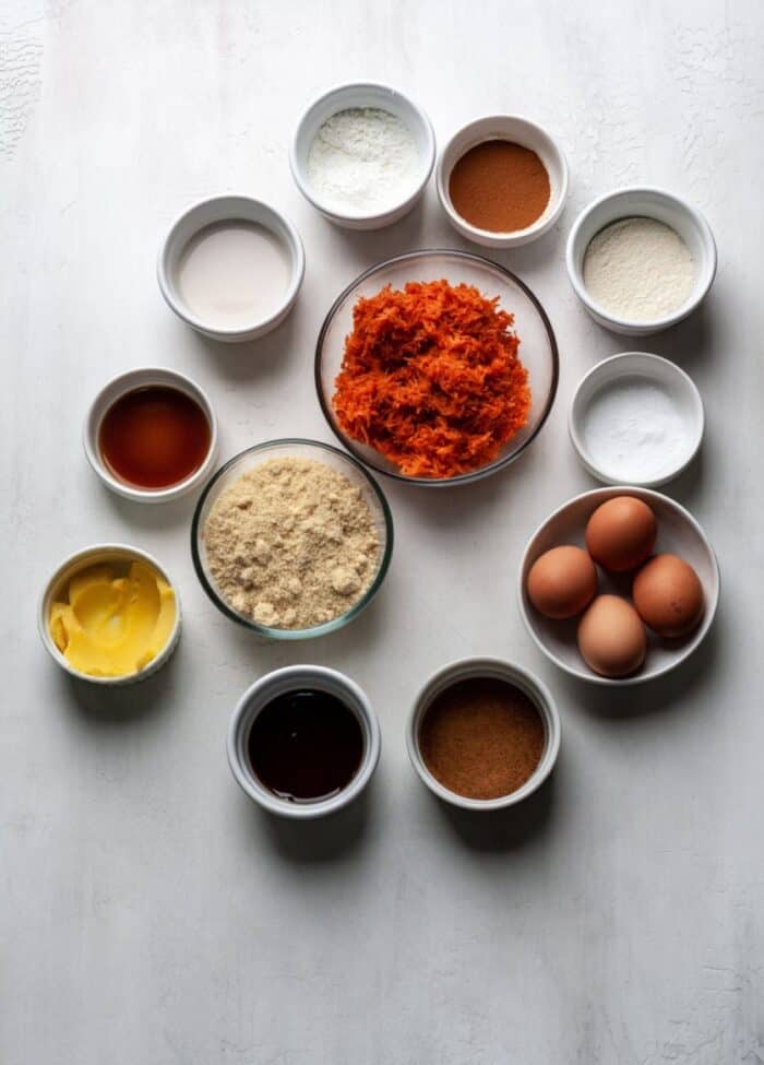 Carrot cake ingredients in small bowls.