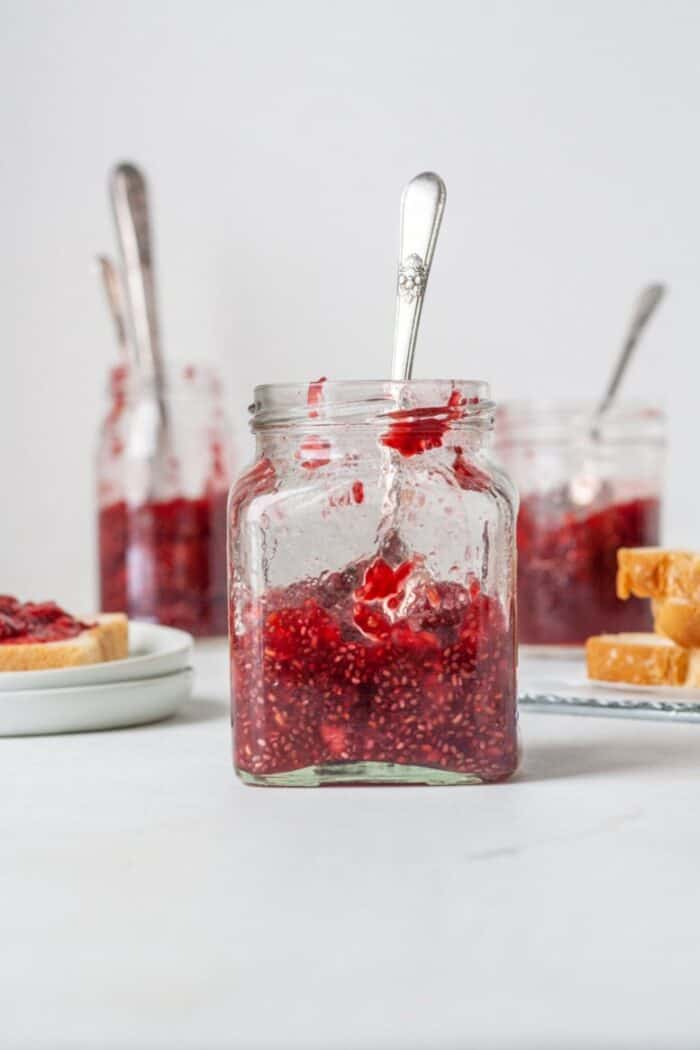 A jar filled with Sugar free jelly made from raspberries and chia seeds.