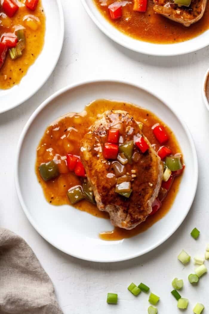 Cajun smothered pork chops on a white plate