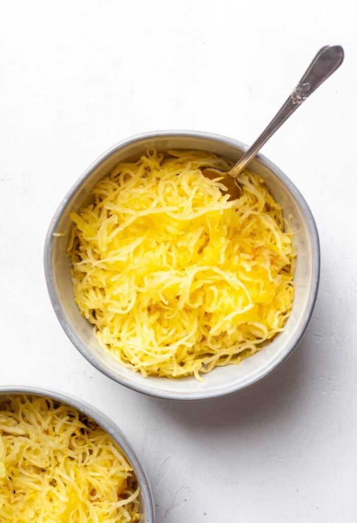 Air fryer spaghetti squash in a gray bowl with spoon