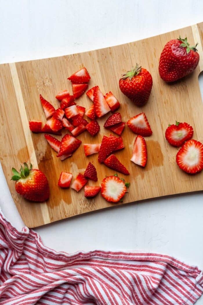 Fresh diced strawberries on cutting board