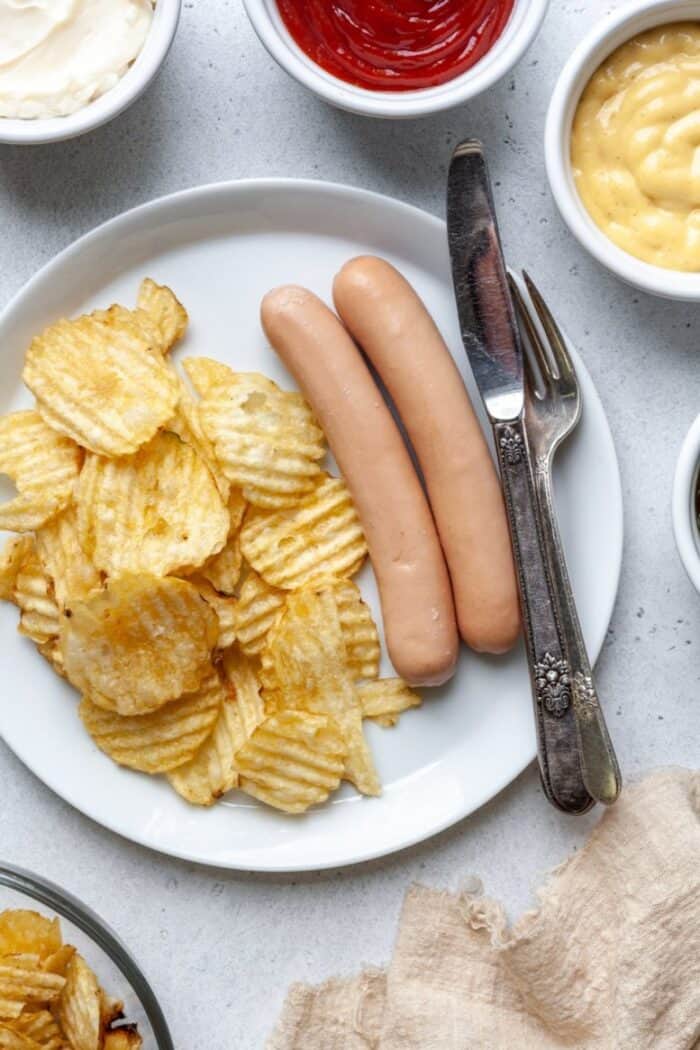 Paleo hot dogs with chips on white plate