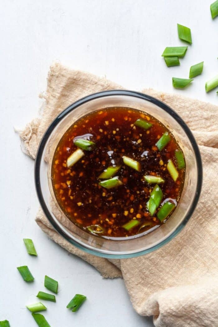 Sugar free stir fry sauce in glass bowl with green onions