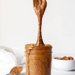 Whole30 almond butter in a Mason jar with spoon