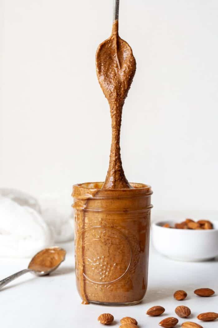 Whole30 almond butter in a Mason jar with spoon