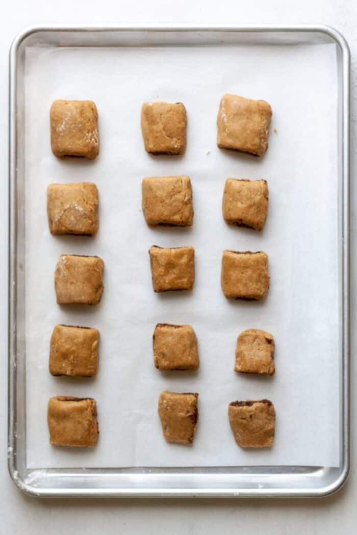 Unbaked fig newtons on baking pan