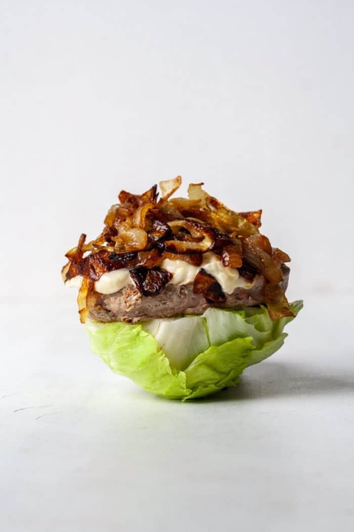 Keto turkey burger with caramelized onions and lettuce wrap