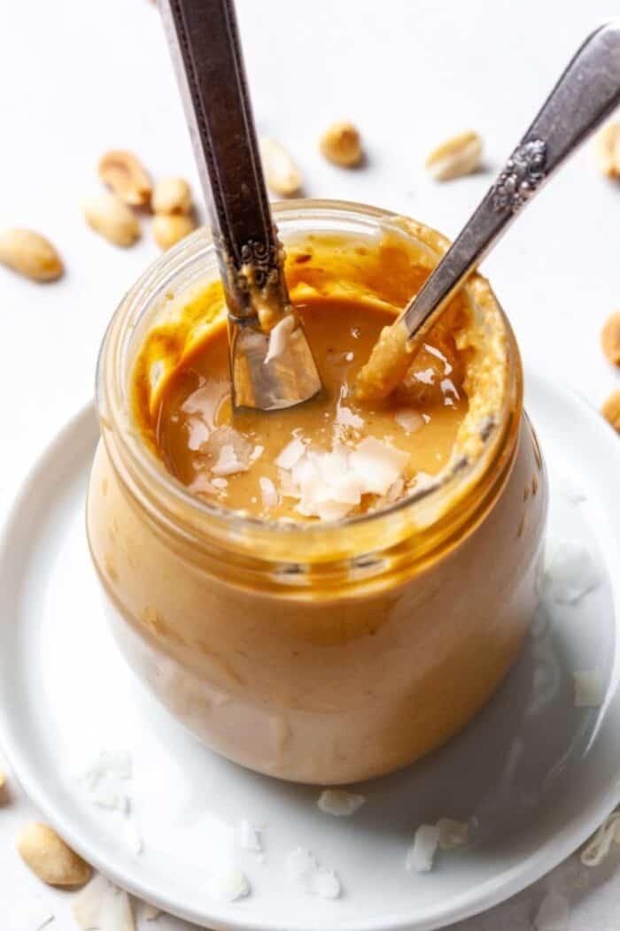Coconut peanut butter in jar with knife
