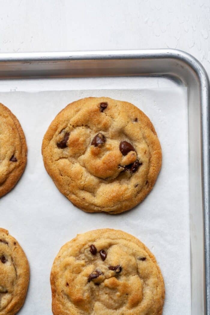 Crispy chocolate chip cookies on pan.