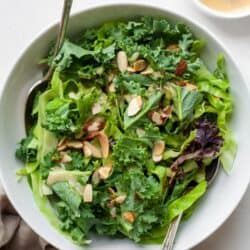 Kale crunch salad in bowl with dressing