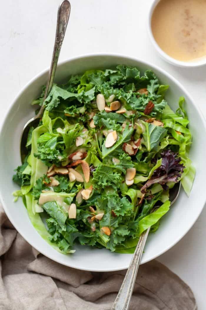 Kale crunch salad in bowl with dressing