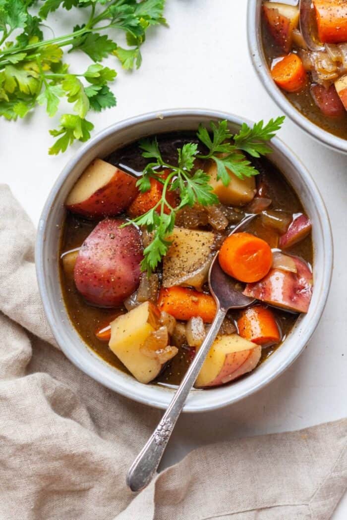 Vegetarian beef stew in bowl with spoon