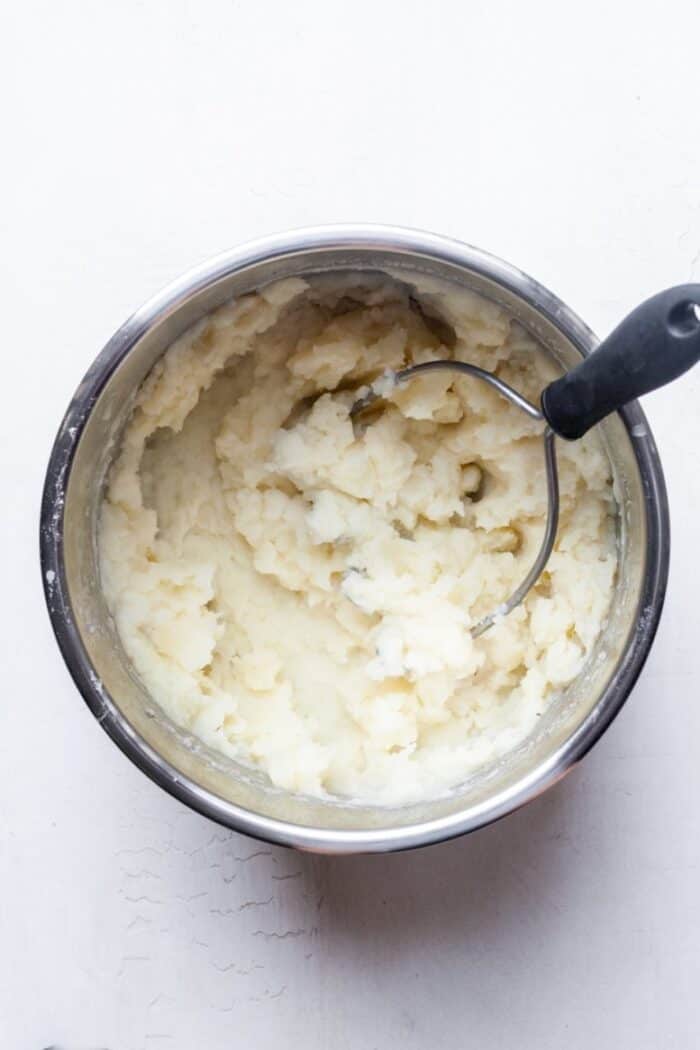 Potato masher with potatoes