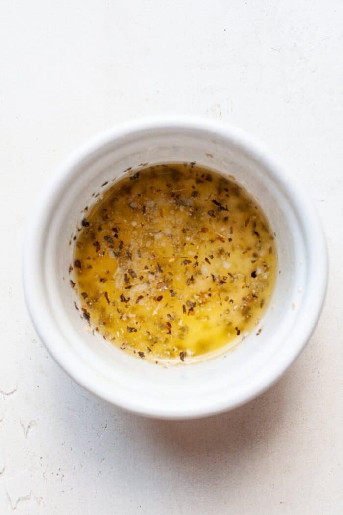 Garlic herb butter sauce in bowl.