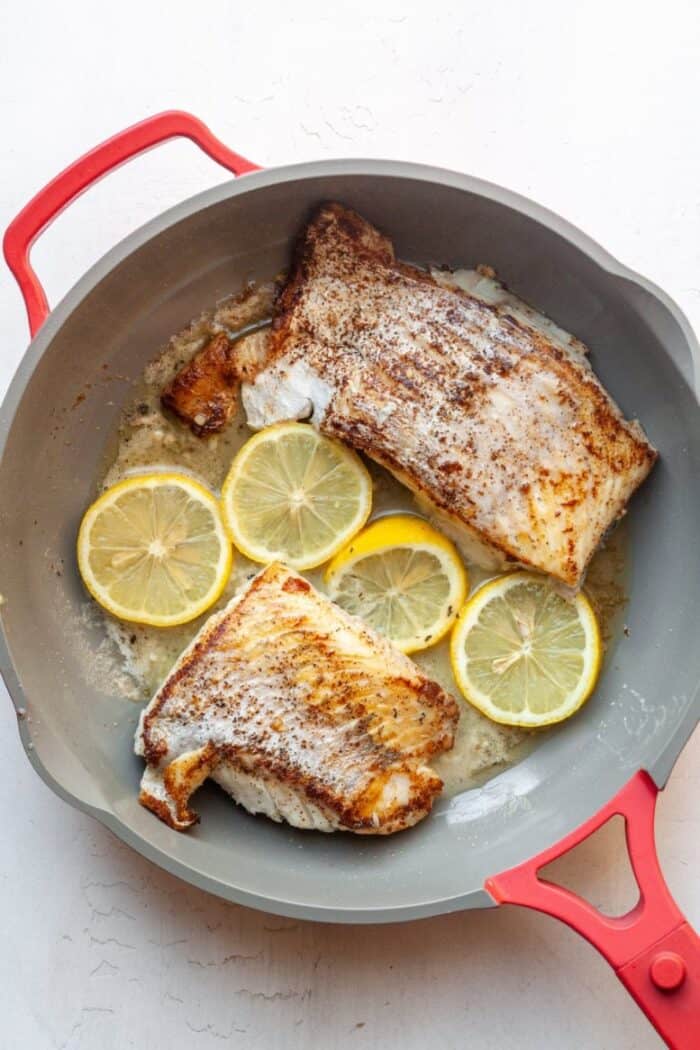 Lemon garlic fish in pan.