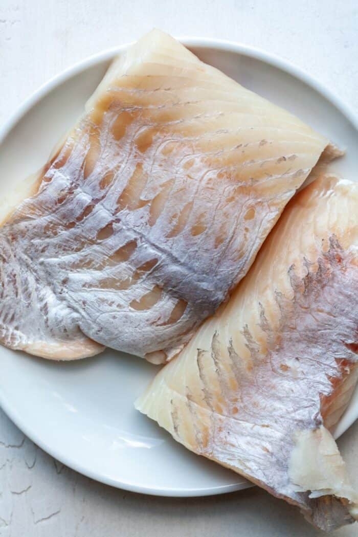 Sea bass on white plate.