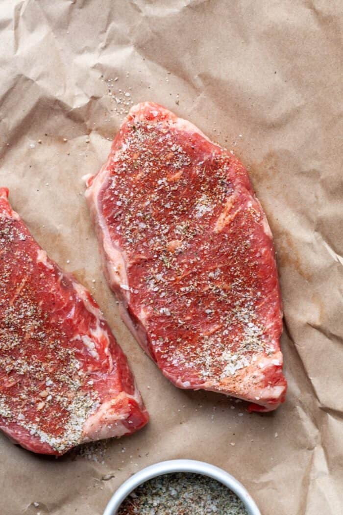 Seasoned sirloin steak on paper
