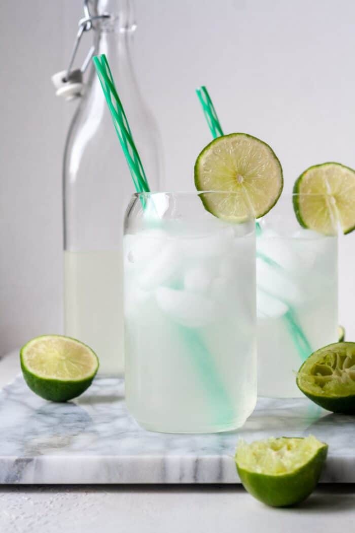 Glasses of lime juice with sliced lime