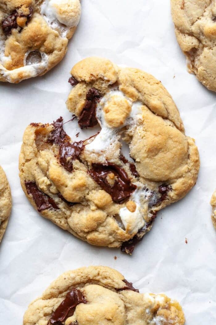 Gooey marshmallow chocolate chip cookies on parchment paper