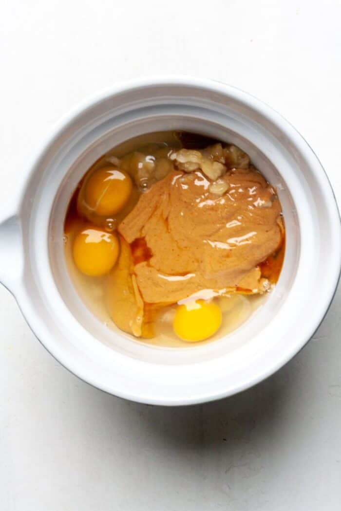 Peanut butter and eggs in mixing bowl