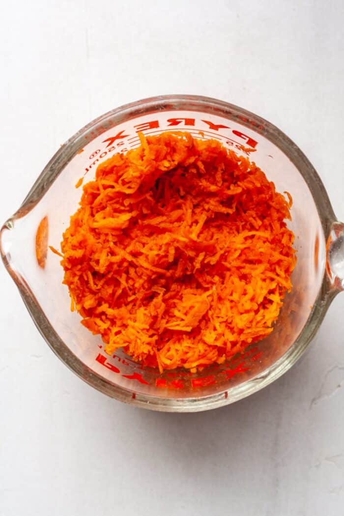 Grated carrots in measuring cup