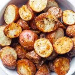 Crispy air fryer diced potatoes in white bowl